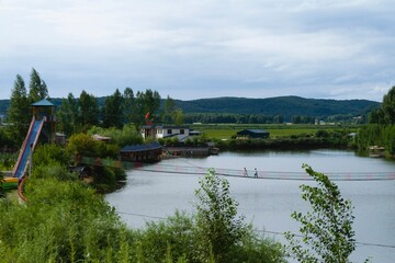 Fototapeta premium Jilin, Jilin, China - July 20 2021: Yanming lake and village in summer.