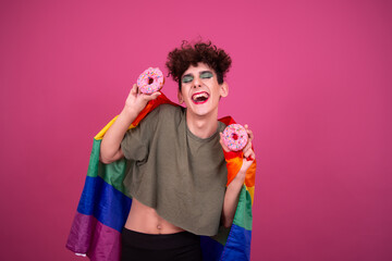 Cheerful drag queen with donuts. Pink background.	