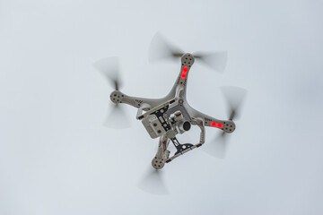 White quadrocopter in the sky.