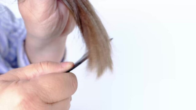 close-up of adult woman combs her hair, combing dirty greasy hair with fine plastic comb, comb out nits and lice with lice, pediculosis. Woman serious hair loss problem, haircut care