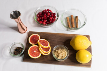 Overhead view of ingredients for fall cocktails on white background