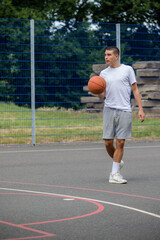 Fototapeta premium A Nineteen Year Old Teenage Boy Playing Basketball