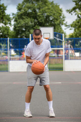 Fototapeta premium A Nineteen Year Old Teenage Boy Playing Basketball