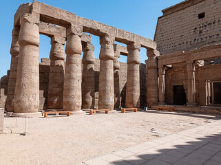 Ruins of an ancient egyptian temple with columns full of hieroglyphs in Egypt