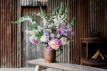 beautiful flowers set up by a florist for a photoshoot in an old barn