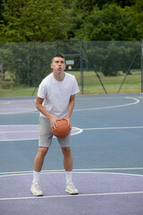 Fototapeta na wymiar A Nineteen Year Old Teenage Boy Playing Basketball