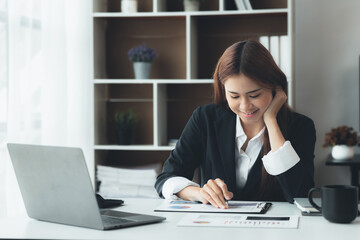 Business woman working in a private office, she is reviewing the company's financial documents sent from the finance department before he takes it to a meeting with a business partner. Financial conce