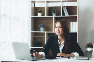 Business woman working in a private office, she is reviewing the company's financial documents sent from the finance department before he takes it to a meeting with a business partner. Financial conce