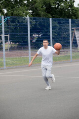 A Nineteen Year Old Teenage Boy Playing Basketball