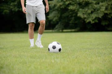 Obraz premium A Nineteen Year Old Teenage Boy Playing Football in A Public Park