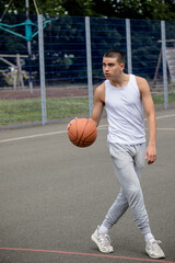 Fototapeta premium A Nineteen Year Old Teenage Boy Playing Basketball