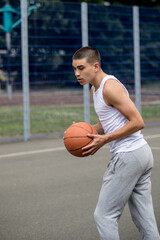 Fototapeta premium A Nineteen Year Old Teenage Boy Playing Basketball