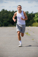 A Nineteen Year Old Teenage Boy Jogging In A Public Park