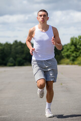 A Nineteen Year Old Teenage Boy Jogging In A Public Park