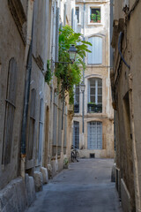 Fototapeta na wymiar Scenic urban landscape of typical narrow street with ancient buildings in the historic center of Montpellier, France