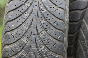 Old winter tires with varying degrees of wear