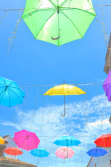 Obraz premium Colorful umbrellas hanging in old town Puerta Vallarta, Mexico