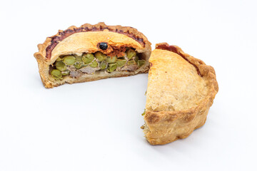 typical Majorcan “ empanada ” with meat, pea and sobrassada on white background