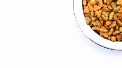 Round metal bowl for pets with dry food. Isolated on white background. View from above. Part of a plate