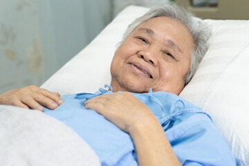 Asian senior or elderly old lady woman patient smile bright face with strong health while lying on...
