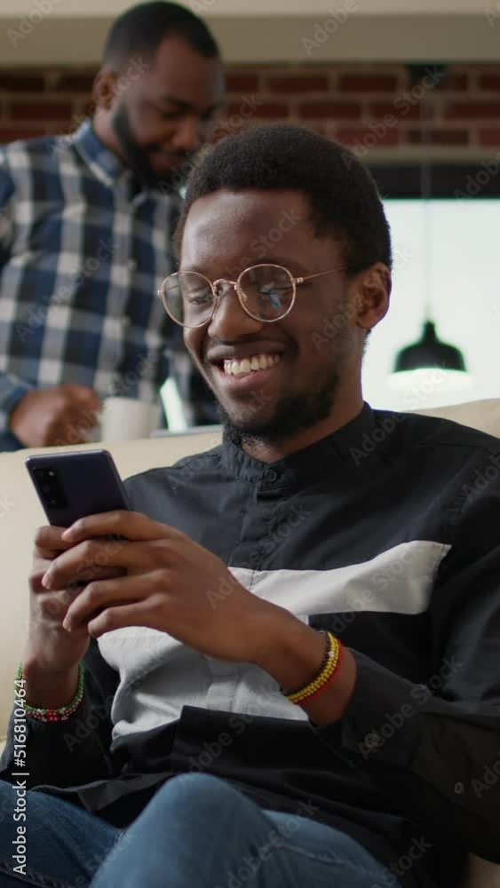 Poster vertical video: office worker sending text messages on social media using mobile phone, using techno