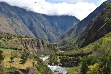Fototapeta na wymiar The dramatic landscapes of the Andes Mountains and cloud forests around the hiking path on the Inca Trail in Peru