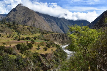 The dramatic landscapes of the Andes Mountains and cloud forests around the hiking path on the Inca Trail in Peru