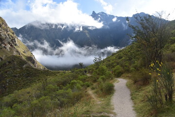 Obraz premium The dramatic landscapes of the Andes Mountains and cloud forests around the hiking path on the Inca Trail in Peru