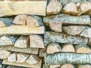 firewood neatly stacked in rows. chopped boards for kindling the stove and cooking on the grill on the farm. texture, background. natural wood