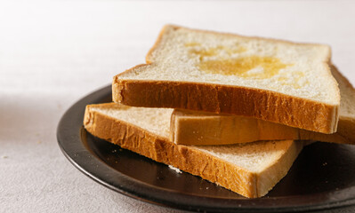 Sliced white bread on a desk. Close up. Bright mood. Horizontal. Suitable for menu and advertising.