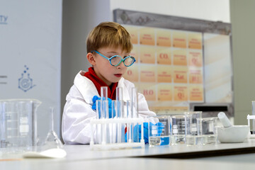 a student in a chemical laboratory conducts chemical sweats with chemical elements