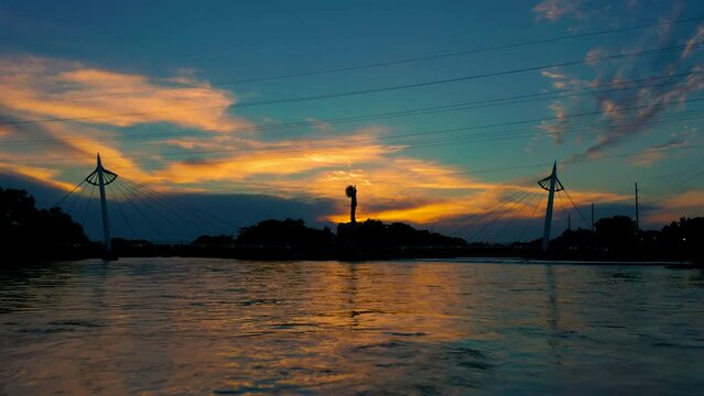Beautiful 4K Drone Video of Arkansas river and Keeper of the Plains at sunset in summer in downtown Wichita Kansas