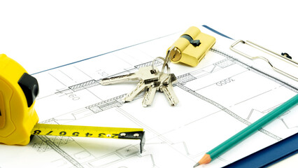 House keys and roulette on the drawings. the concept of construction and purchase of new housing