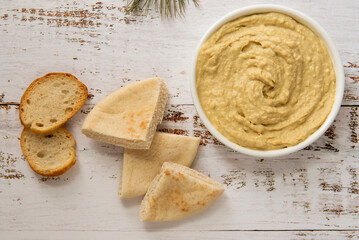 Fresh homemade hummus with pita and toasted baguette