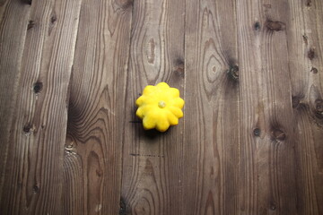 squash of star shape and yellow color on wooden table