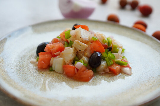 Esqueixada, Cod fish salad with tomato and onion, olives , typical Catalan dish,Spain 