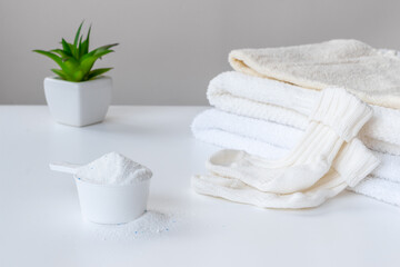 Flatlay of laundry detergents powder with fresh towels