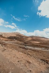 landscape of a desolate dry mountain terrain in Deosai National Park in north Pakistan on sunny day