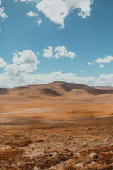 beautiful orange valley with hills on sunny day in Deosai National Park in Pakistan