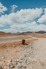 one single empty trash can in the middle of a desolate dry desert in Deosai National Park on sunny day in Pakistan