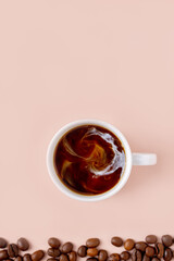 cup of coffee with cream and coffee beans, copy space