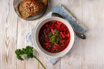 vegetable vegetarian soup in a plate, on a white wooden background
