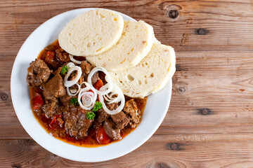 Fine Meat - Beef Goulash in a with Red Pepper on table. Top view. Copy space