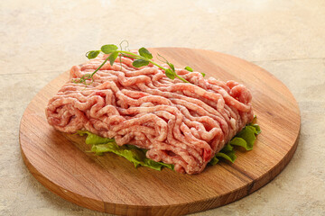 Raw minced pork meat over board