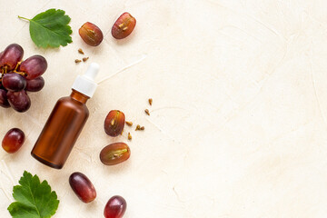 Bottle of grape seed essential oil with grapes. Eco cosmetic product