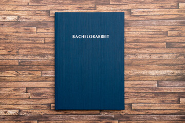 Printed and bound Bachelorarbeit (bachelor thesis) in Germany. Book with a blue cover to graduate...
