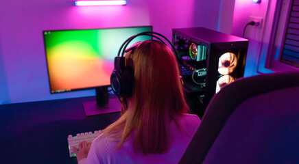 A Professional female pro gamer play online video games cyber sport and esport winner emotion. Young woman in tournament match worldwide in room colorful neon lights.