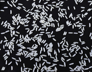 Scattered rice on a dark background. Close-up