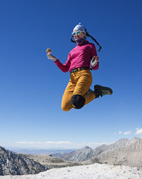 Woman Jumps On Mountain Top