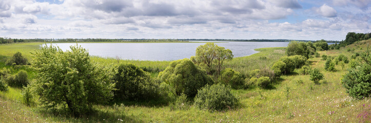 Sunny day and cloudy sky on the lake